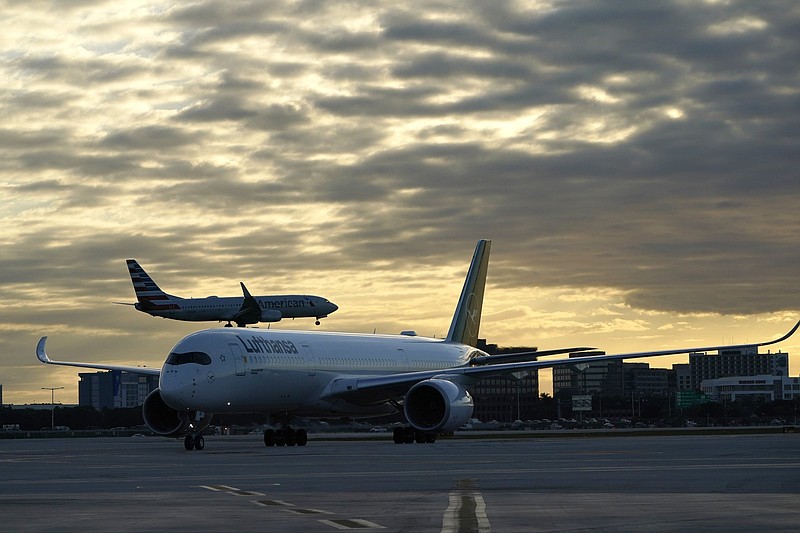 A Lufthansa flight arrives from Munich, Germany, as an American Airlines aircraft takes off at Miami International Airport recently. The holiday travel season will test whether the nation’s air carriers can withstand the highest passenger volumes of the pandemic era.
(AP/Lynne Sladky)