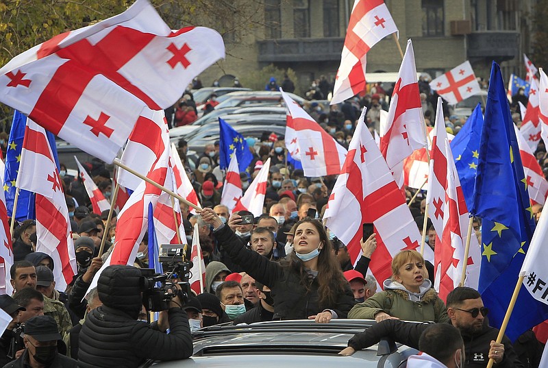 Opposition demonstrators with Georgian national and European Union flags attend a rally Friday in support of former President Mikheil Saakashvili in Tbilisi, Georgia. More photos at arkansasonline.com/1120tbilisi/.
(AP/Shakh Aivazov)