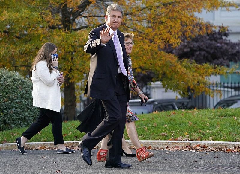 Sen. Joe Manchin, D-W.Va., walks on the White House campus, Thursday, Nov. 18, 2021, in Washington. (AP Photo/Evan Vucci)