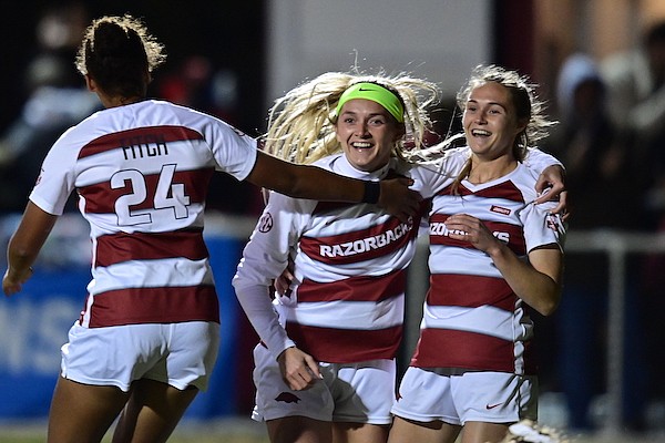 Arkansas soccer players Van Fitch (left), Parker Goins (center) and Anna Podojil celebrate a goal during an NCAA Tournament game against Notre Dame on Sunday, Nov. 21, 2021, in Fayetteville.