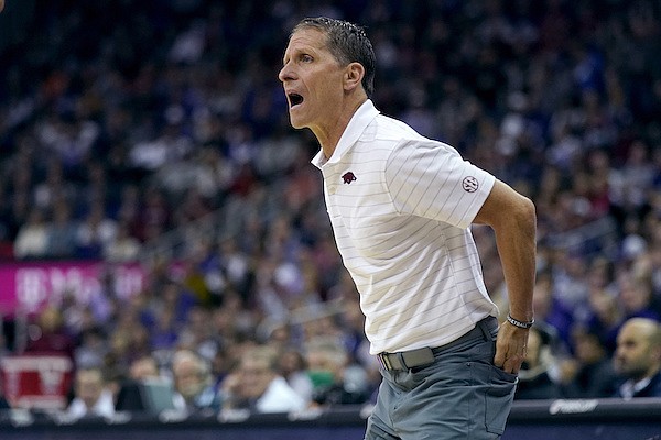 Arkansas head coach Eric Musselman talks to his players during the first half of an NCAA college basketball game against Kansas State Monday, Nov. 22, 2021, in Kansas City, Mo. (AP Photo/Charlie Riedel)