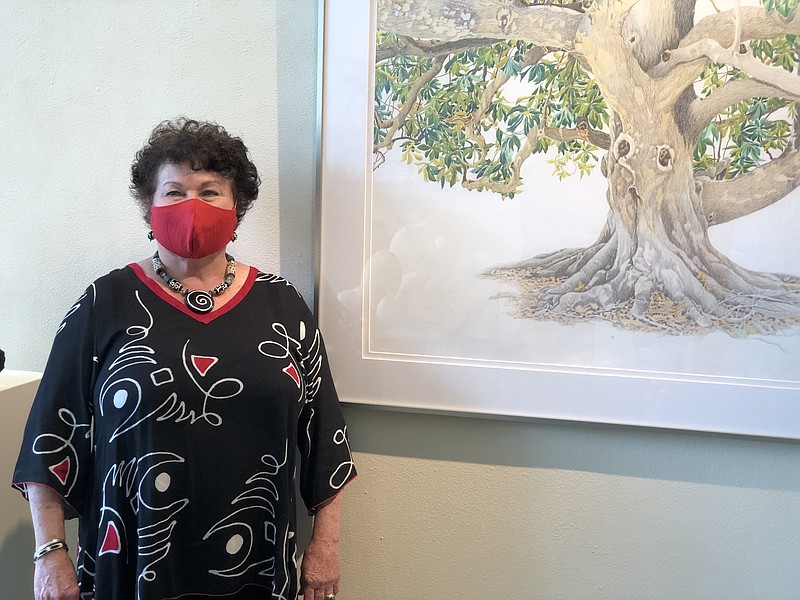 Artist Linda Williams Palmer stands next to her artwork “Southern Magnolia.” (Democrat-Gazette file photo)