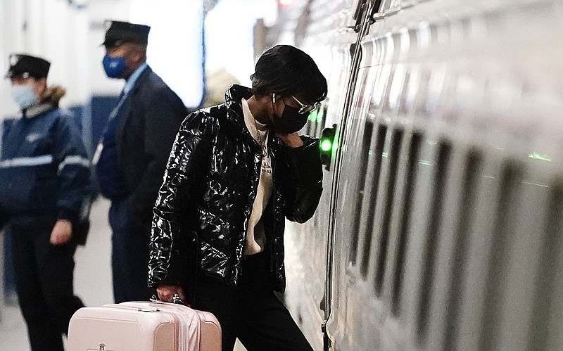 A traveler boards an Amtrak train Wednesday at the 30th Street Station in Philadelphia. Millions of Americans are brushing aside concerns about a resurgence in coronavirus cases to celebrate Thanksgiving with loved ones again.
(AP/Matt Rourke)