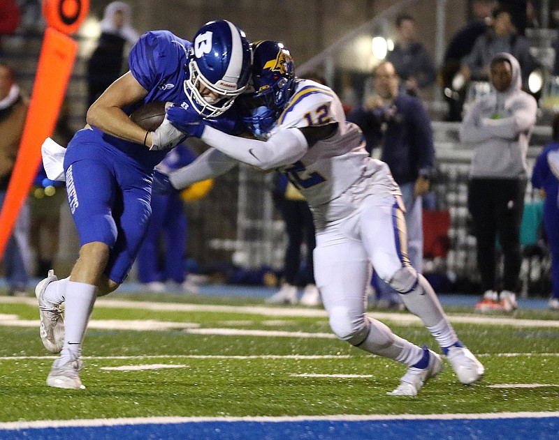 Bryant wide receiver Blake Everett (left) fights his way into the end zone for a touchdown while being hit by North Little Rock defensive back Joshua Thrower during the teams’ Oct. 29 game in Bryant. The Hornets have won the past six meetings against the Charging Wildcats, and they will meet their 7A-Central Conference rivals once again Friday night in the Class 7A semifinals.
(Arkansas Democrat-Gazette/Thomas Metthe)