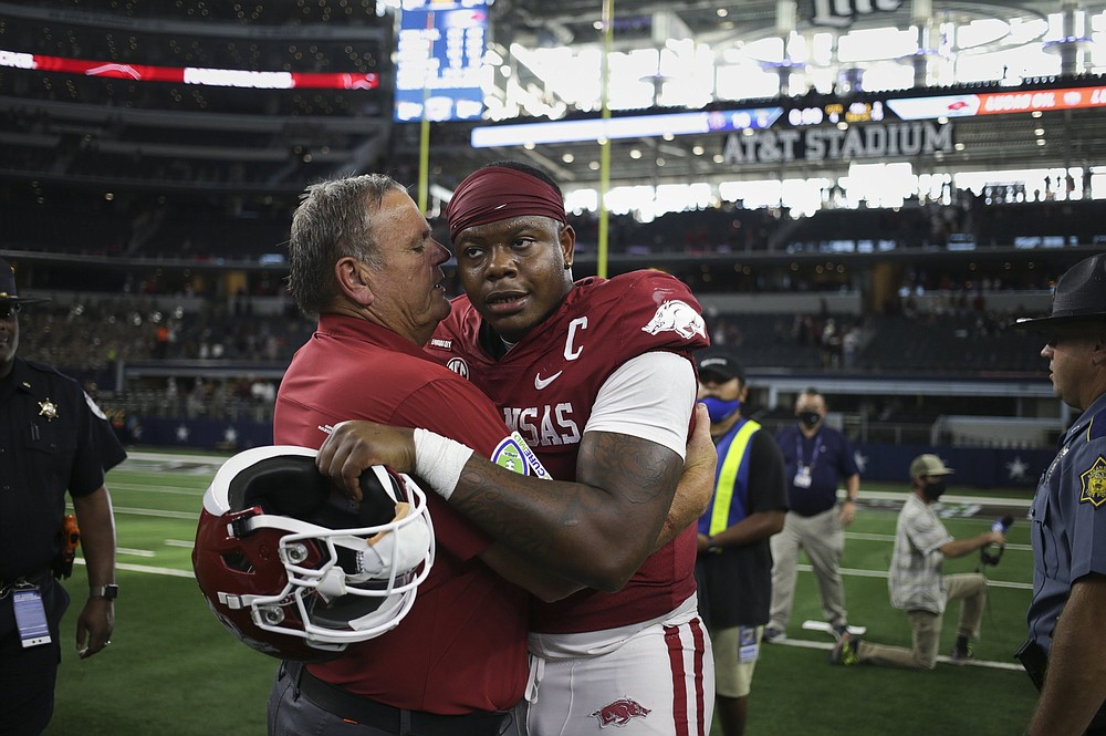 Coach Sam Pittman (left) talks to quarterback KJ Jefferson after Arkansas’ victory over Texas A&amp;M on Sept. 25 in Arlington, Texas. Pittman has led the Razorbacks to seven victories and a bowl game in his second season in charge.
(NWA Democrat-Gazette/Charlie Kaijo)