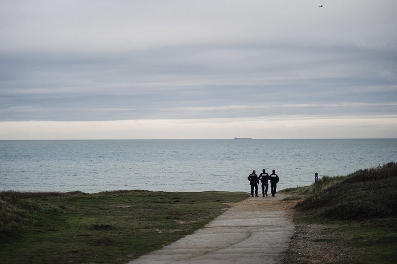 French police officers keep an eye out for migrant arrivals as they patrol a beach last week in Wimereux, France.
(AP/Louis Witter)