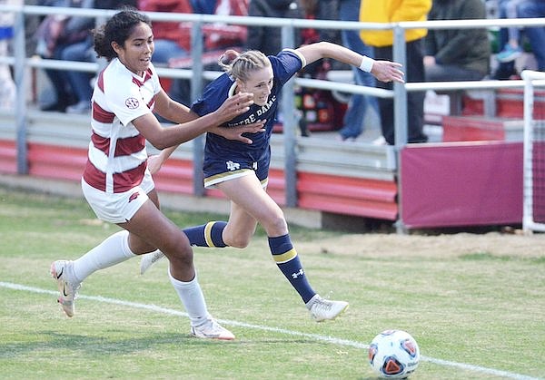 Arkansas' Bryana Hunter (left) and Notre Dame's Olivia Wingate battle for possession during an NCAA Tournament game Sunday, Nov. 21, 2021, in Fayetteville.