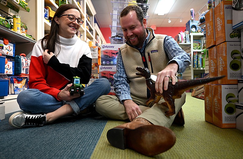 Caroline and Jon Holcomb play with toys Tuesday in their Little Rock store, The Toggery, one of about a dozen family-owned toy stores remaining in Arkansas.
(Arkansas Democrat-Gazette/Stephen Swofford)