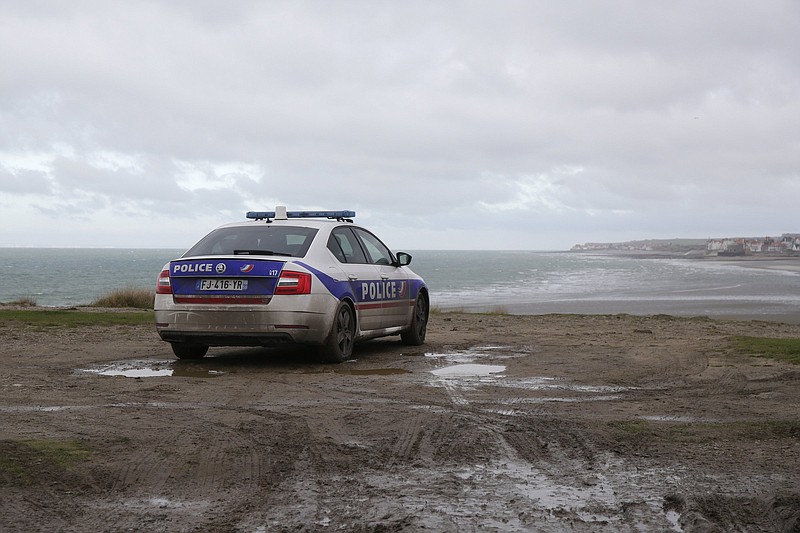 A police car sits parked by the shore Thursday in Calais, northern France. Video at arkansasonline.com/1126channel/.
(AP/Michel Spingler)