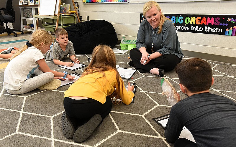 Teacher Nakia Richter works with a group of her third-grade students this month at Evening Star Elementary in Bentonville.
(NWA Democrat-Gazette/Flip Putthoff)