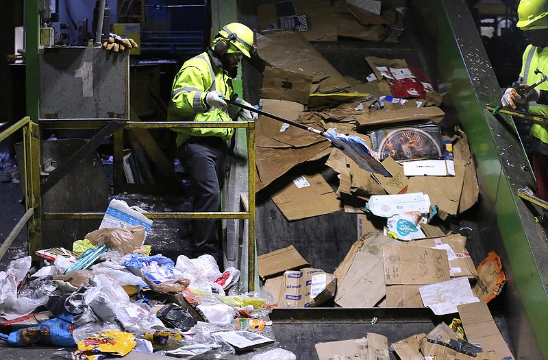 FILE — Jabrarie Blount sorts trash from cardboard boxes as the refuse travels up a conveyor belt at the Waste Management Little Rock Recycling Facility in this 2021 file photo.
(Arkansas Democrat-Gazette/Thomas Metthe)