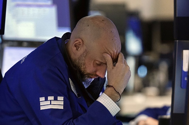 Specialist Meric Greenbaum works at his post on the floor of the New York Stock Exchange on Friday. Stocks closed sharply lower for the day. Video at arkansasonline.com/1127dowdown/.
(AP/Richard Drew)