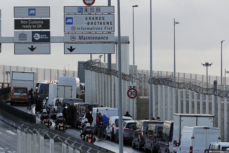 Cars and trucks are stopped as French fishermen block the entrance of the Eurotunnel, in Coquelles, northern France, on Friday. Video at arkansasonline.com/1127fishing/.
(AP/Michel Spingler)