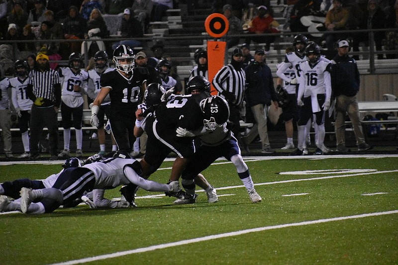 White Hall quarterback Mathew Martinez breaks tackles for a first down Friday at Bulldog Stadium. The Bulldogs will play in the state championship for the first time in 34 years after beating Little Rock Christian Academy 24-14. 
(Pine Bluff Commercial/I.C. Murrell)