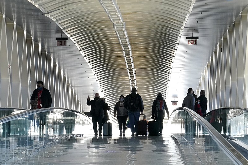 Travelers cross a pedestrian bridge between terminals Wednesday at Logan International Airport in Boston.
(AP/Steven Senne)
