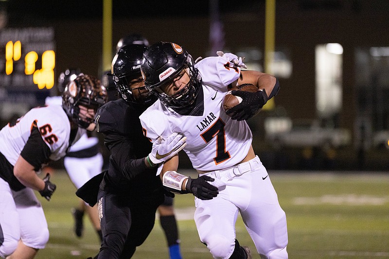 Joe T. Robinson’s G’Kyson Wright (left) tackles Lamar’s Tony Balmer on Friday night in Little Rock. More photos are available at arkansasonline.com/1127lhsjtr/.
(Arkansas Democrat-Gazette/Justin Cunningham)