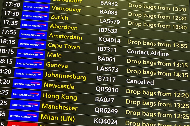 A departures screen at London's Heathrow Airport on Friday, Nov. 26, 2021, displays a canceled flight to Johannesburg and a message to contact the airline for a scheduled flight to Capetown. The U.K. announced that it was banning flights from South Africa and five other southern African countries effective at noon on Friday, and that anyone who had recently arrived from those countries would be asked to take a coronavirus test. (AP/Alberto Pezzali)