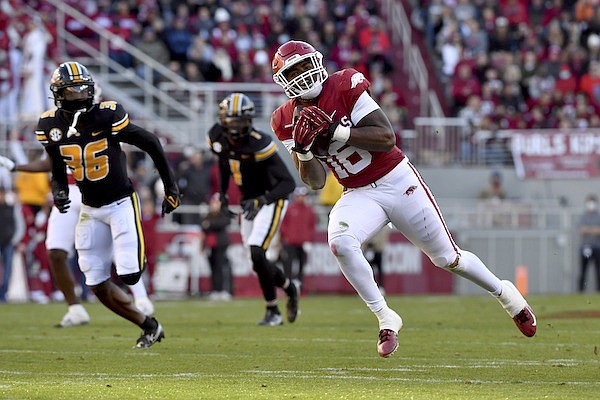 Arkansas receiver Treylon Burks (16) makes a catch in front of Missouri defensive back DJ Jackson (36) during the first half of an NCAA college football game Friday, Nov. 26, 2021, in Fayetteville. (AP Photo/Michael Woods)