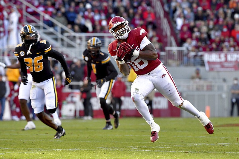 Arkansas receiver Treylon Burks (16) makes a catch in front of Missouri defensive back DJ Jackson (36) during the first half in Fayetteville on Friday, Nov. 26, 2021. (AP/Michael Woods)