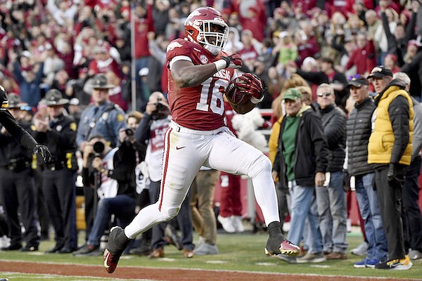 Arkansas receiver Treylon Burks (16) runs for a touchdown after a big catch against Missouri during the second half of an NCAA college football game Friday, Nov. 26, 2021, in Fayetteville, Ark. (AP Photo/Michael Woods)