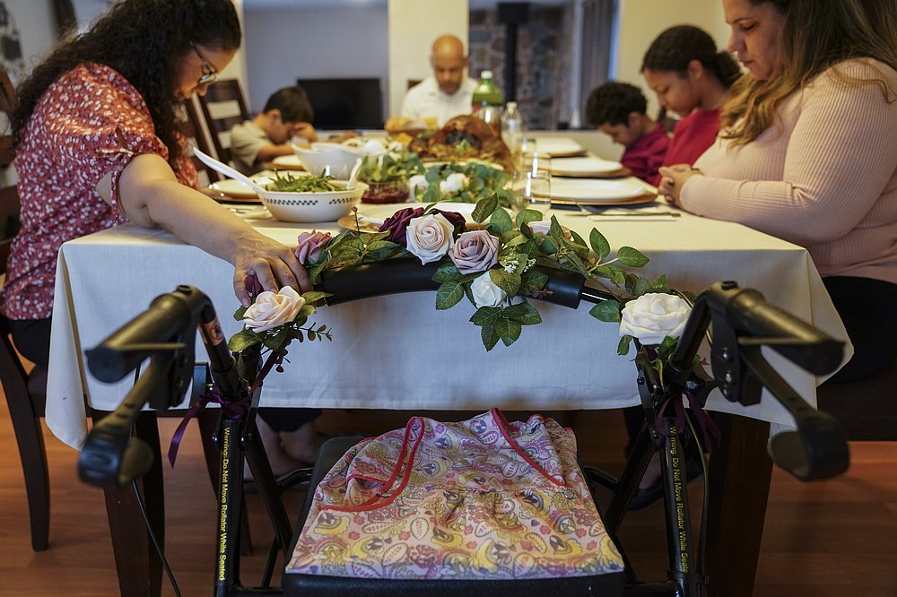 The Zayas family in Deer Park, N.Y., which said grace before eating their Thanksgiving dinner last year, left a spot at the table for Vivian Zayas, who had died on April 1, 2020, at age 78, while recovering from knee replacement surgery. For many Americans, pre-meal prayers are a ritual, not only during the holidays, but year round.
(AP/John Minchillo)