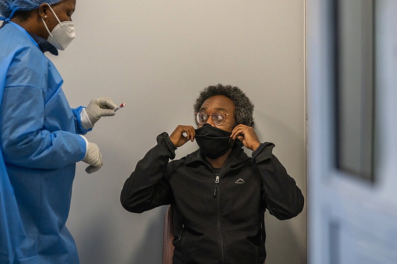 A medical worker conducts a coronavirus test Saturday, Nov. 27, 2021, in Johannesburg, South Africa, where cases of the new omicron variant have begun surging. (AP/Jerome Delay)