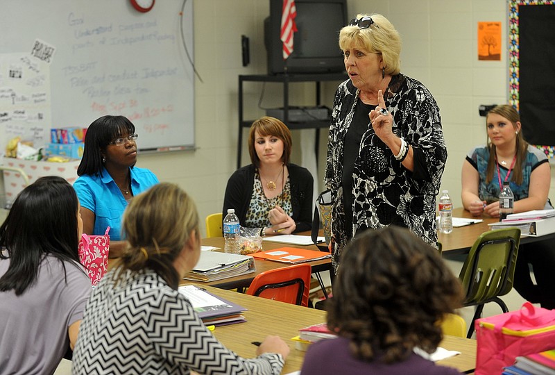 Ginger Osburn, a University of Arkansas-Fort Smith assistant professor, talks with students training to be teachers during class at a professional development school housed within Central Elementary in Van Buren in this Sept. 25, 2013, file photo. The students, then seniors, were taking courses required before they moved on to internships, also called student teaching. (Northwest Arkansas Democrat-Gazette file photo)