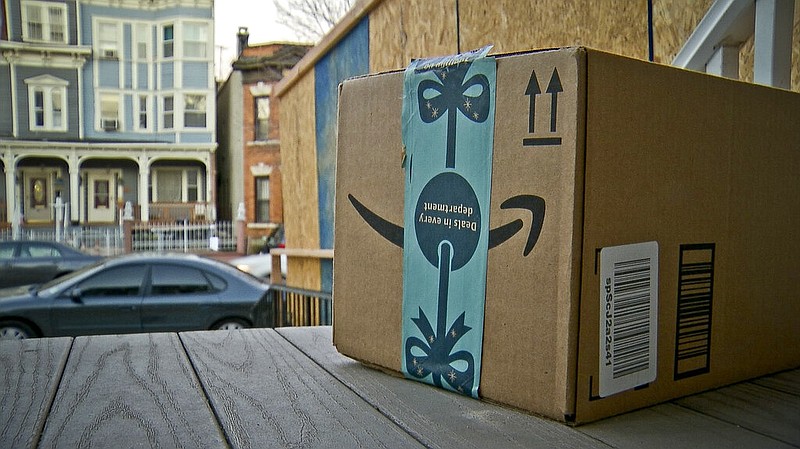 An Amazon package containing a GPS tracker is shown on the porch of a Jersey City, N.J., residence after its delivery in this Dec. 11, 2018, file photo. (AP/Robert Bumsted)