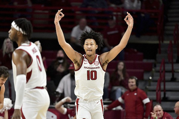 Arkansas forward Jaylin Williams (10) reacts after hitting a three point shot against Pennsylvania during the second half of an NCAA college basketball game Sunday, Nov. 28, 2021, in Fayetteville, Ark. (AP Photo/Michael Woods)