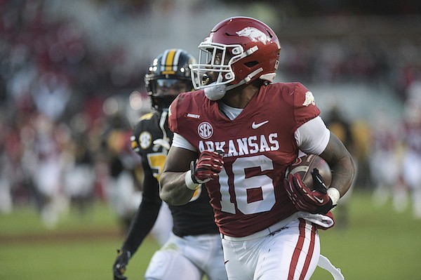 Arkansas wide receiver Treylon Burks outruns a Missouri defender to score a touchdown during the third quarter of the Razorbacks’ victory over the Tigers in Fayetteville.
