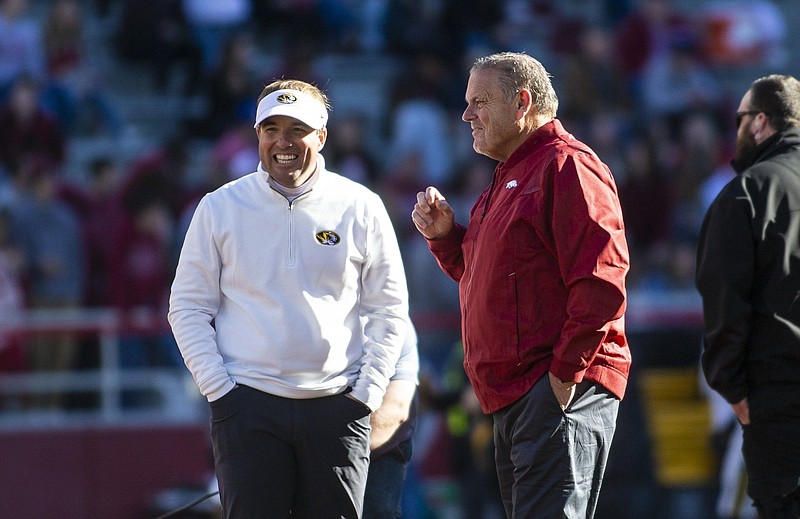 Eliah Drinkwitz, head football coach of Missouri and Sam Pittman, head football coach at Arkansas share a laugh before game on  Friday, Nov. 26 2021, during the first half of play at Reynolds Razorback Stadium, Fayetteville. Visit nwaonline.com/211027Daily/ for today's photo gallery..(Special to the NWA Democrat-Gazette/David Beach)