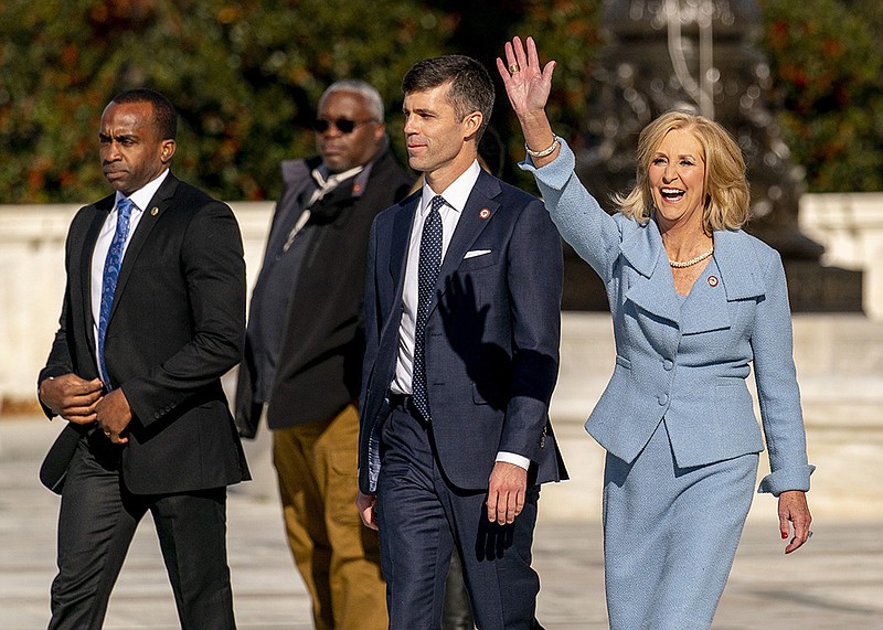 Mississippi Attorney General Lynn Fitch, accompanied by Mississippi Solicitor General Scott Stewart (center, left), waves to supporters Wednesday as they leave the U.S. Supreme Court.
(AP/Andrew Harnik)