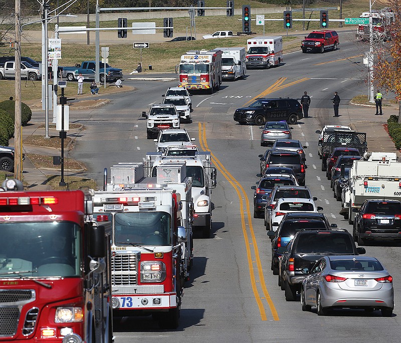 A procession of emergency vehicles make its way along JFK Boulevard during the funeral of MEMS paramedic Maj. Dean Douglas on Wednesday in North Little Rock.
(Arkansas Democrat-Gazette/Thomas Metthe)