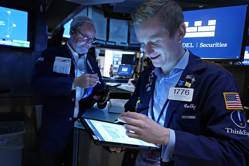 Traders David O’Day (left) and Colby Nelson work Wednesday on the floor of the New York Stock Exchange.
(AP/Richard Drew)