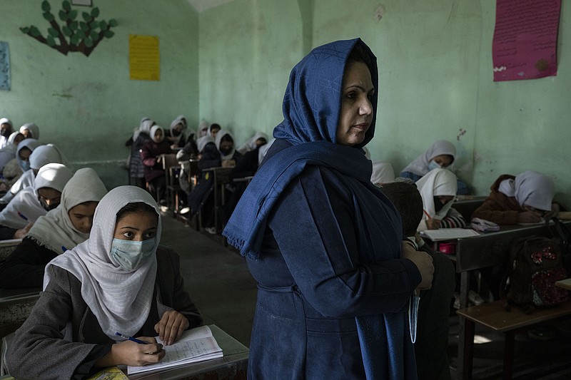 A teacher gives a lesson to a classrom of Afghan girls at Tajrobawai Girls High School in Herat, Afghanistan, in late November. Herat is the only place where girls’ high schools are open across the province, although schools also have reopened in a few individual districts in northern Afghanistan.
(AP/Petros Giannakouris)