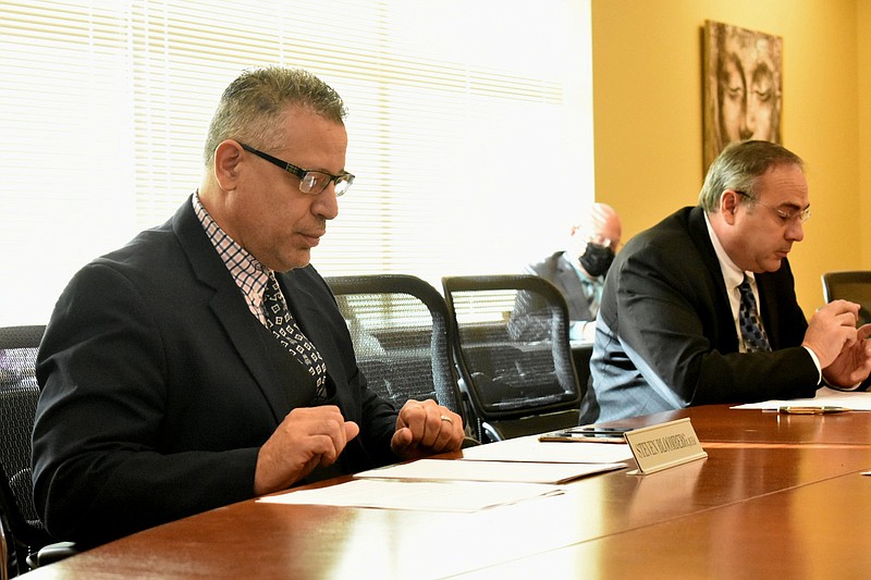 Southeast Arkansas College President Steven Bloomberg (left) and college board Chairman Rob Cheatwood proceed with a board meeting Thursday to approve plans for a new student center and residential hall. 
(Pine Bluff Commercial/I.C. Murrell)