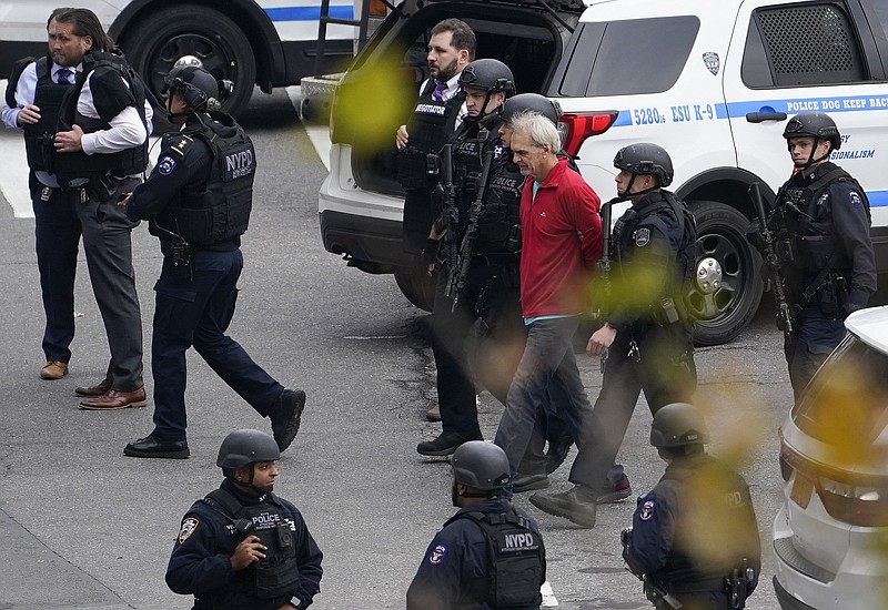 New York police arrest a man Thursday who had been standing with a gun outside the United Nations headquarters until he surrendered, ending a standoff.
(AP/John Minchillo)