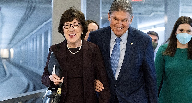 Sen. Joe Manchin, a key vote on President Joe Biden’s domestic spending agenda, walks through the Senate subway area Thursday with Sen. Susan Collins, R-Maine. Manchin unexpectedly expressed openness Thursday to a GOP-led amendment to block enforcement of federal vaccination and testing policies.
(AP/Jacquelyn Martin)