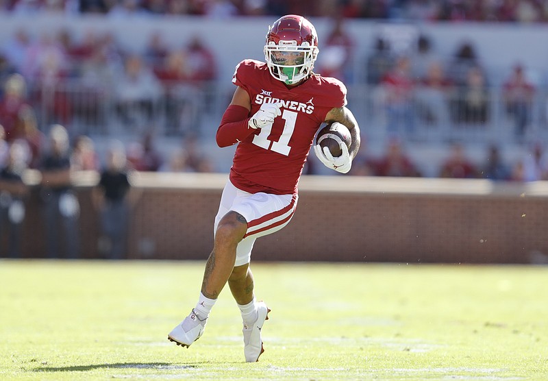 Oklahoma wide receiver Jadon Haselwood (11) runs for a first down during the first half an NCAA college football game against Oklahoma, Saturday, Oct. 30, 2021, in Norman, Okla. (AP Photo/Alonzo Adams)