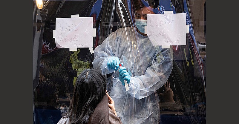 A covid-19 test is administered Friday at a mobile site near Grand Central Terminal in New York. Five cases of the omicron variant had been detected in New York by Thursday, with more cases showing up in nine other states, so far.
(AP/Yuki Iwamura)