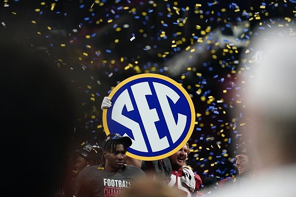 Alabama players hold a championship sign after the Southeastern Conference championship NCAA college football game between Georgia and Alabama, Saturday, Dec. 4, 2021, in Atlanta. Alabama won 41-24. (AP Photo/Brynn Anderson)