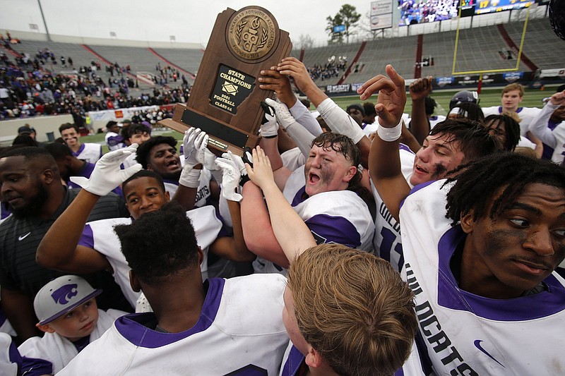 El Dorado players celebrate after the Wildcats' 27-17 win over Greenwood in the Class 6A state championship game on Saturday, Dec. 4, 2021, at War Memorial Stadium in Little Rock. .More photos at www.arkansasonline.com/125state6a/.(Arkansas Democrat-Gazette/Thomas Metthe)