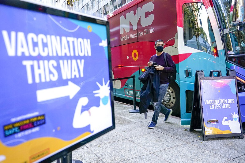 A man walks off a vaccination bus at a NYC mobile vaccine clinic in Midtown Manhattan, Monday, Dec. 6, 2021. (AP/Mary Altaffer)