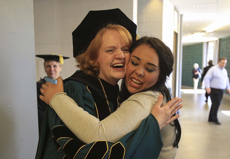 Arkansas Tech University President Robin E. Bowen (left) hugs then-student Katie Frazier after Bowen's inauguration ceremony at Tucker Coliseum in Russellville in this April 17, 2015, file photo. (Arkansas Democrat-Gazette/Staton Breidenthal)