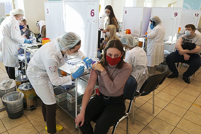 A medical worker administers a shot of Russia’s Sputnik V coronavirus vaccine Friday at a vaccination center in Moscow.
(AP/Pavel Golovkin)