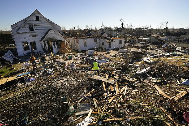 Voluteers help Martha Thomas, second left, salvage possessions from her destroyed home, in the aftermath of tornadoes that tore through the region, in Mayfield, Ky., Monday, Dec. 13, 2021. (AP/Gerald Herbert)
