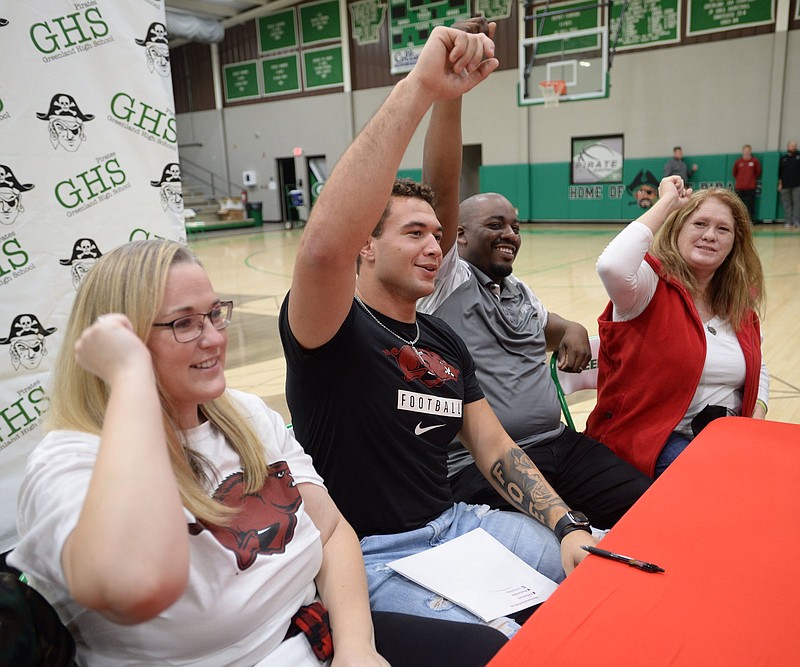 Arkansas signee JJ Hollingsworth of Greenland (center) calls the Hogs alongside his mother Amy Johnson (from left), father Jaye Johnson and grandmother Janet Hollingsworth. More photos are available at arkansasonline.com/1216deeleegym/
(NWA Democrat-Gazette/Andy Shupe)