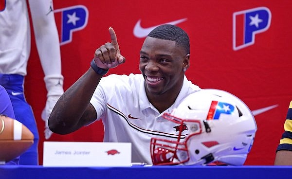 Little Rock Parkview running back James Jointer reacts to a member of the audience before signing his intent to play college football for the University of Arkansas at a ceremony at Parkview High School in Little Rock on Wednesday, Dec. 15, 2021.