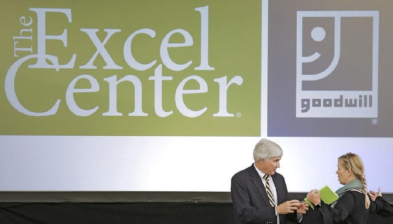 Brad Walker (left) talks with Betsy Delgado after an event in Little Rock in this September 2017 file photo. The event announced the opening of The Excel Center, an adult high school under the aegis of Goodwill Industries of Arkansas. (Arkansas Democrat-Gazette file photo)