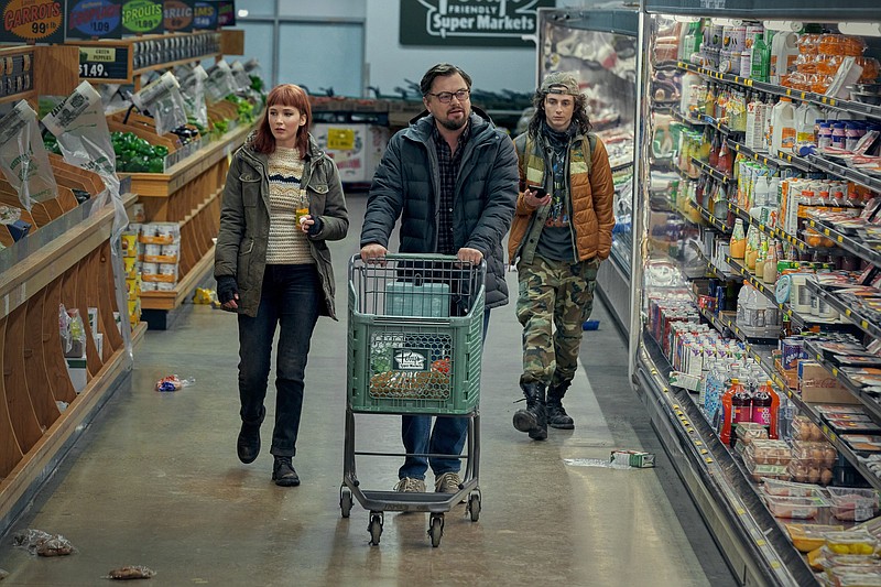 Kate Dibiasky (Jennifer Lawrence), Dr. Randall Mindy (Leonardo DiCaprio) and Yule (Timothee Chalamet) go shopping while waiting for the world to end in Adam McKay’s sledgehammer satire “Don’t Look Up.”